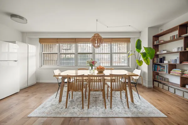 a view of a dining room with furniture window and wooden floor