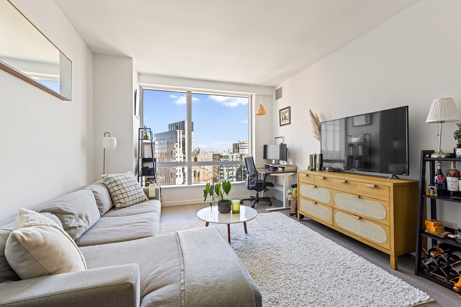 1 City Point, Unit 36D Brooklyn, NY 11201 - Photo 1 of 16 a living room with furniture and a flat screen tv