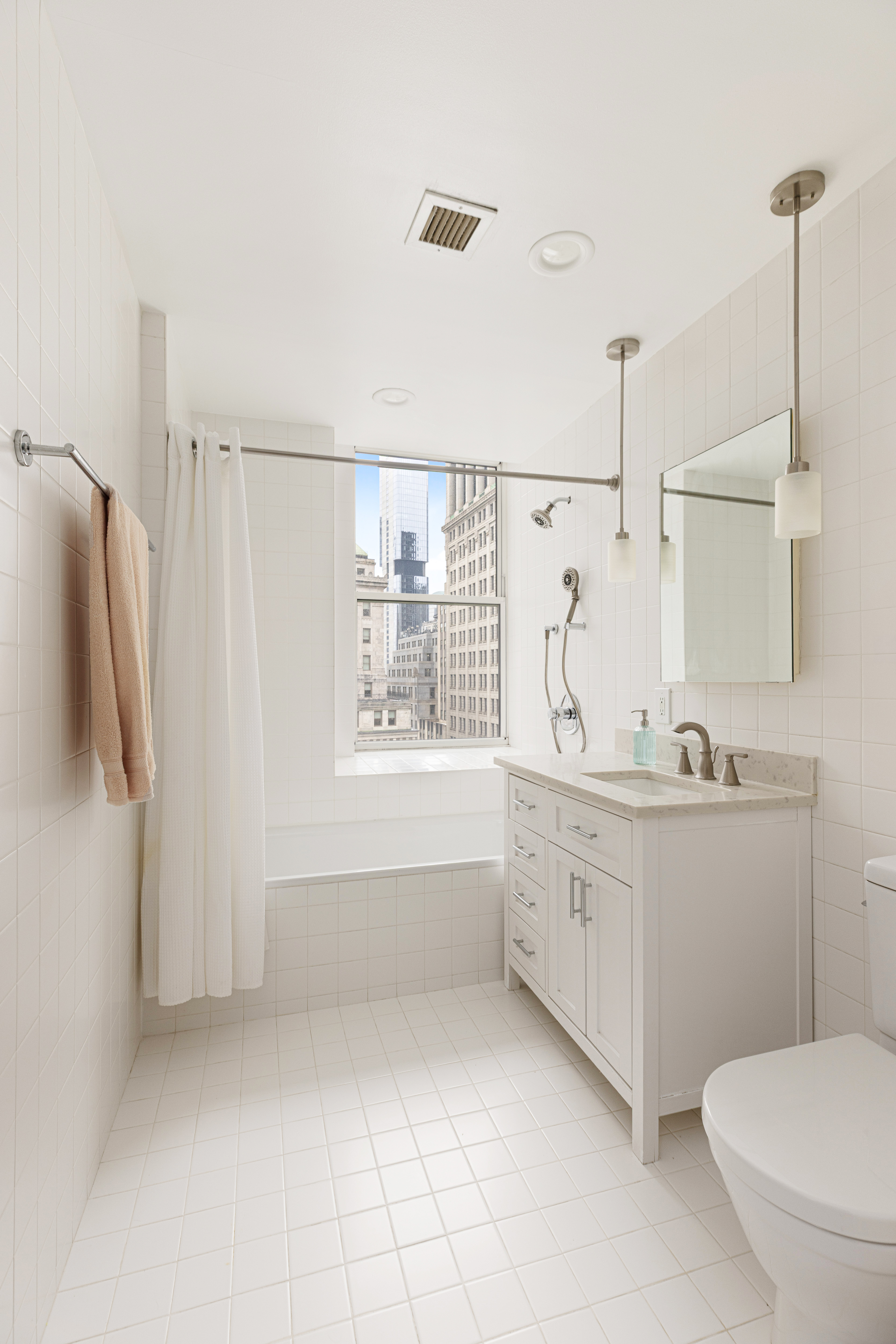 15 Broad Street, Unit 2300 Manhattan, NY 10005 - Photo 12 of 36 a bathroom with a granite countertop sink a toilet and shower