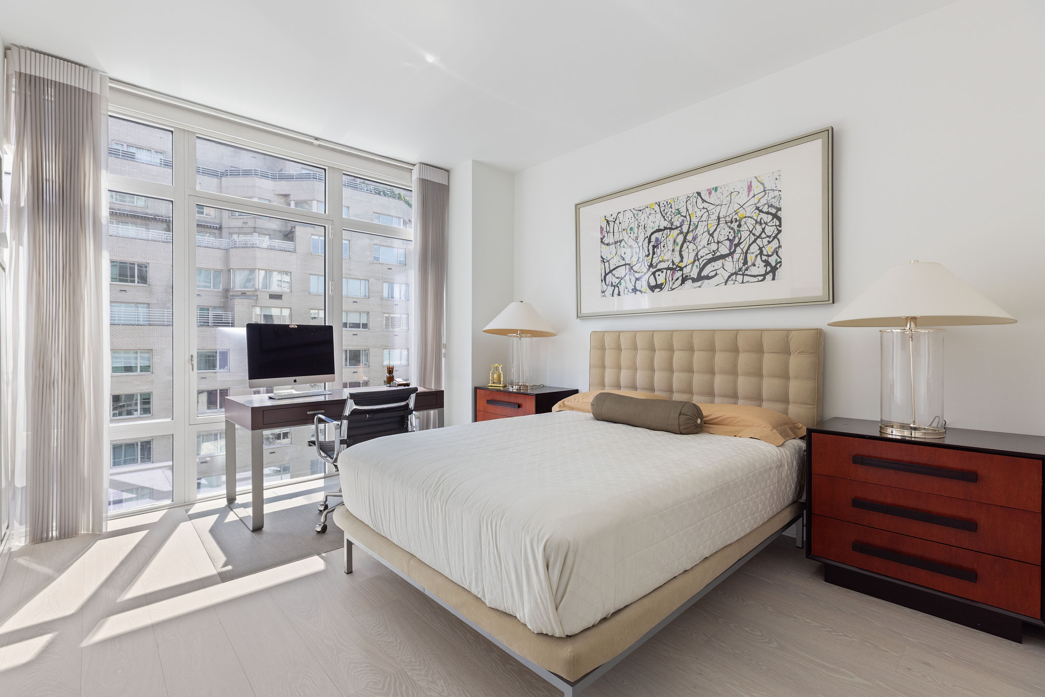 207 East 57th Street, Unit 14B Manhattan, NY 10022 - Photo 6 of 8 a bedroom with a bed and a flat screen tv