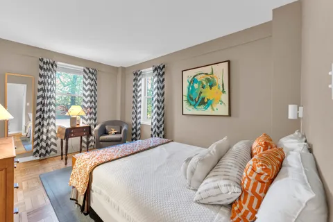 a bed sitting in a bedroom next to a window