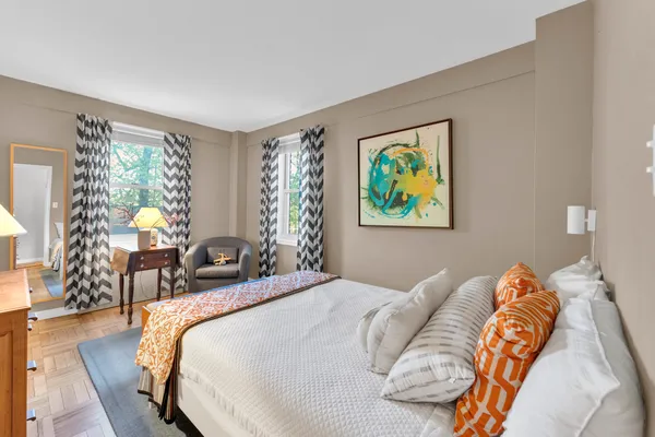 a bed sitting in a bedroom next to a window
