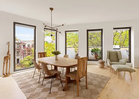 a view of a dining room with furniture window and outside view
