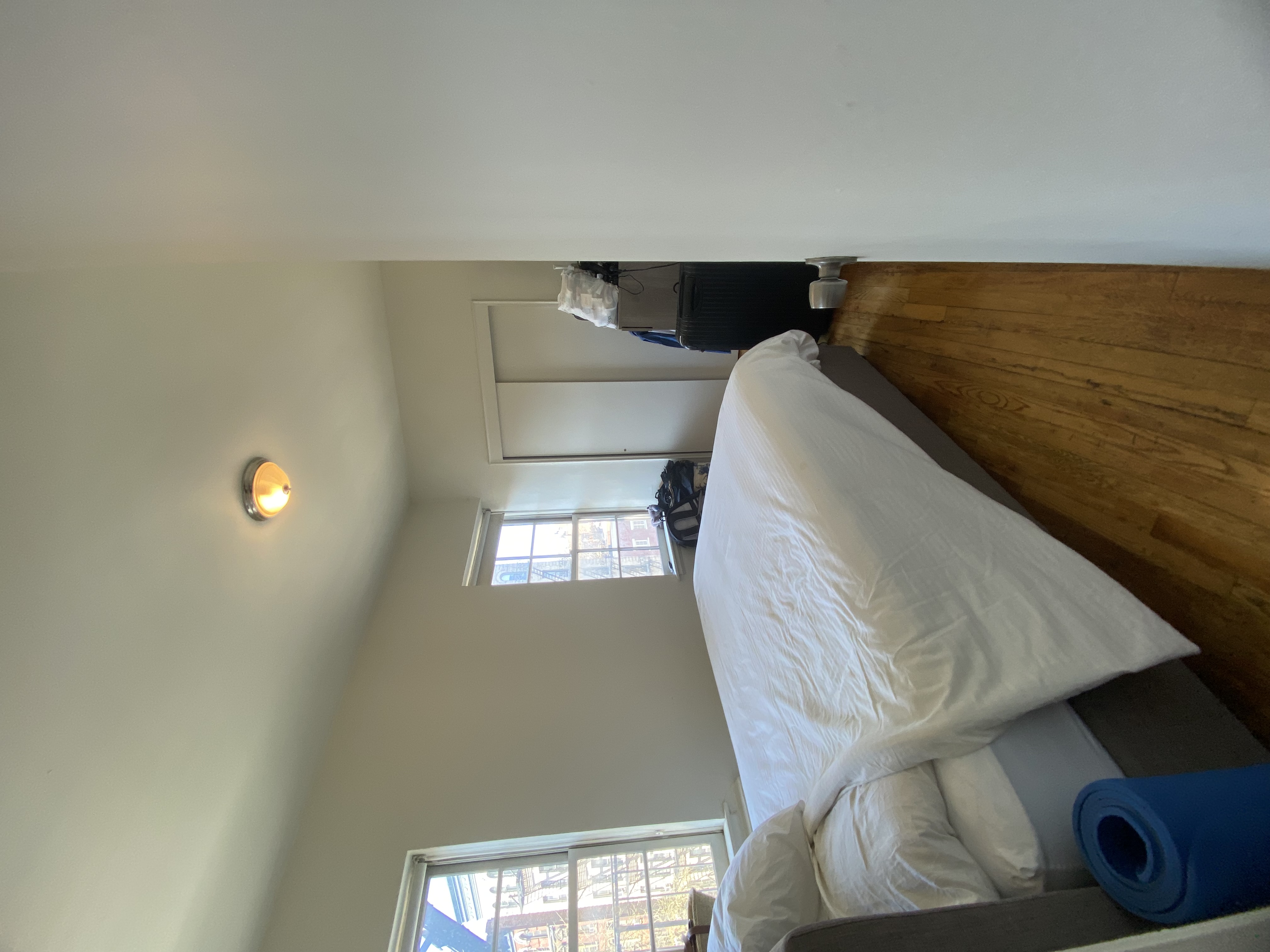 108 Perry Street, Unit 3C Manhattan, NY 10014 - Photo 4 of 6 a bedroom with a bed and window