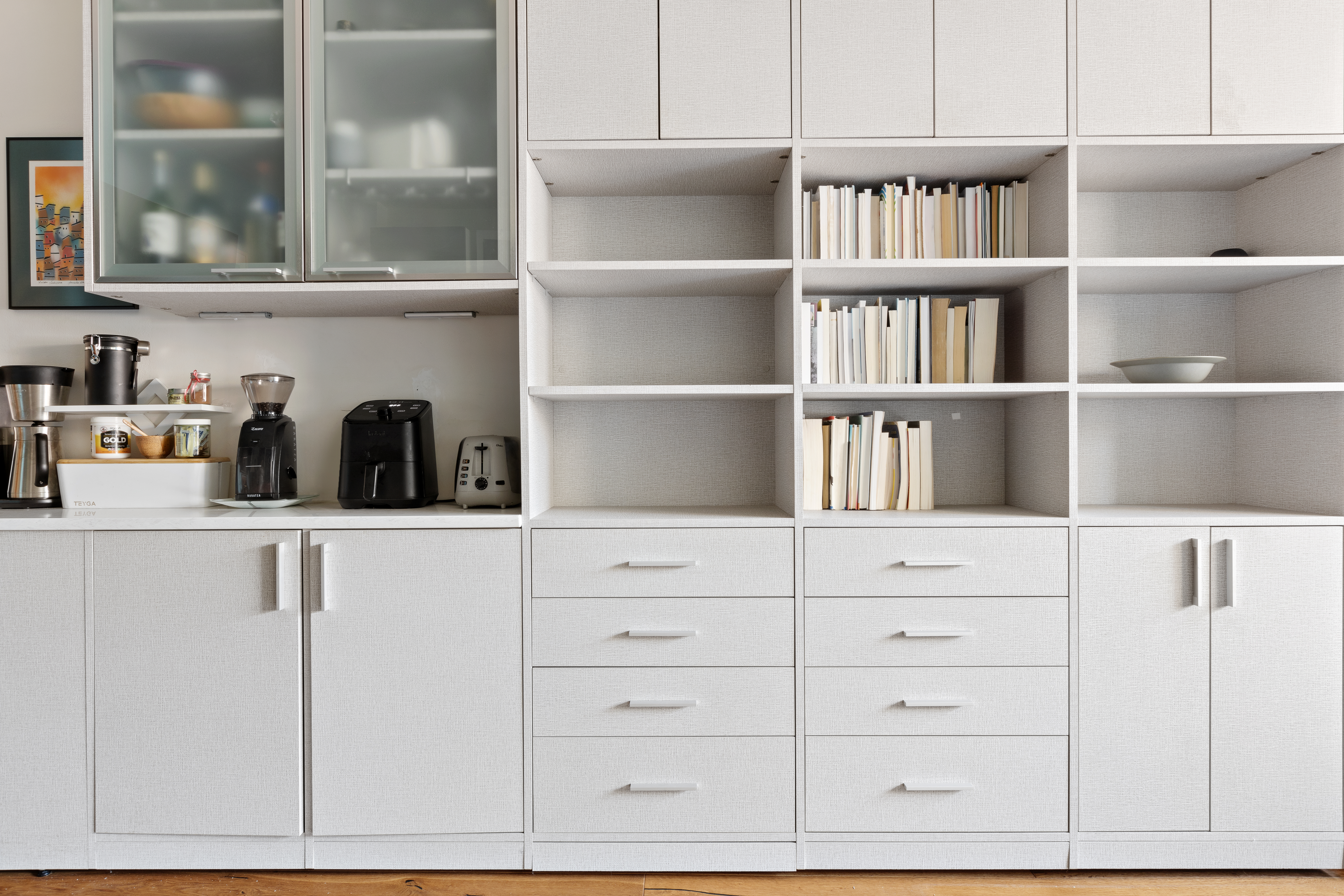 101 West 12th Street, Unit 9D Manhattan, NY 10011 - Photo 2 of 8 a kitchen with white cabinets and a window