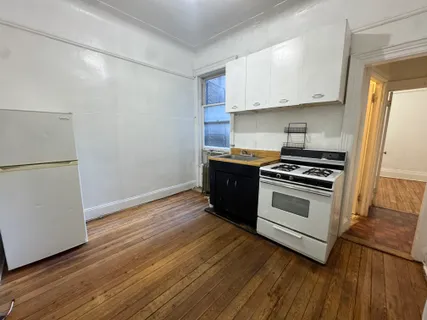 a kitchen with granite countertop a stove and a refrigerator