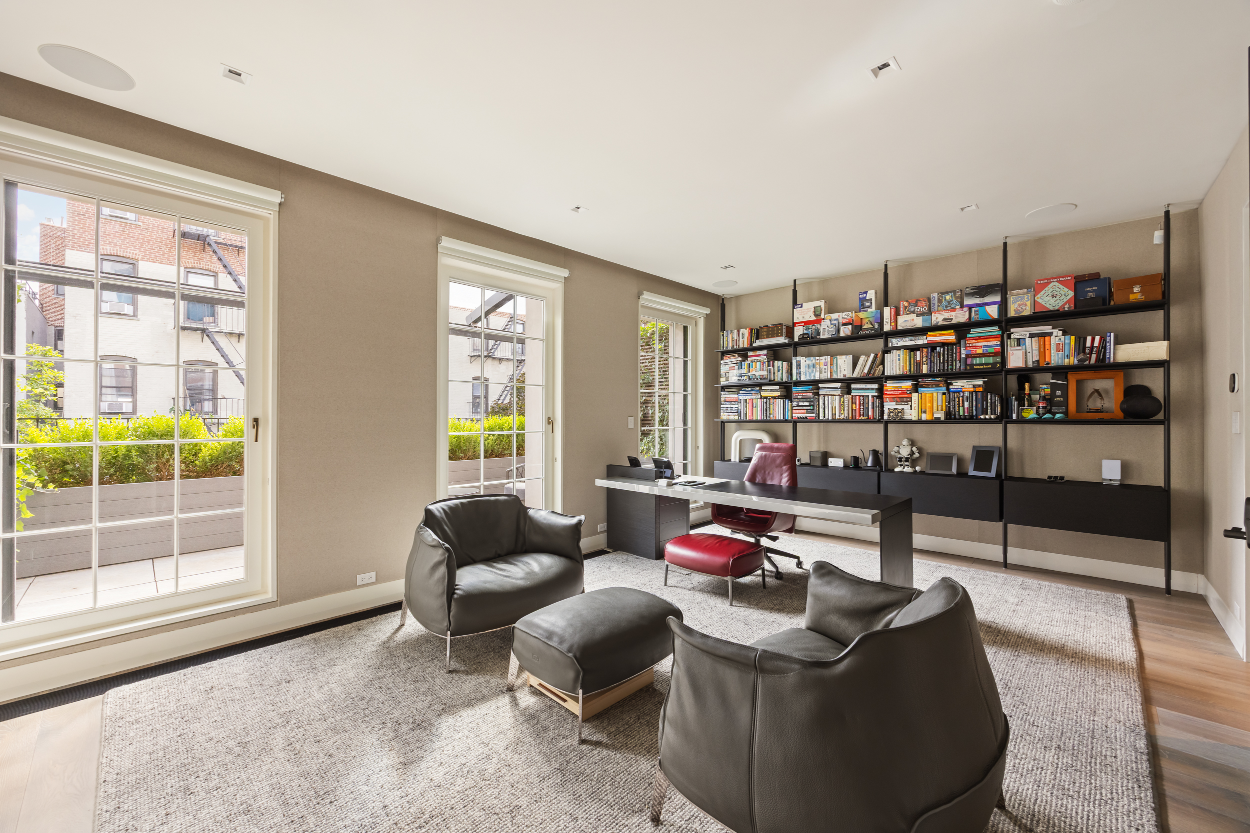 146 Waverly Place Manhattan, NY 10014 - Photo 30 of 41 a living room with furniture and a book shelf