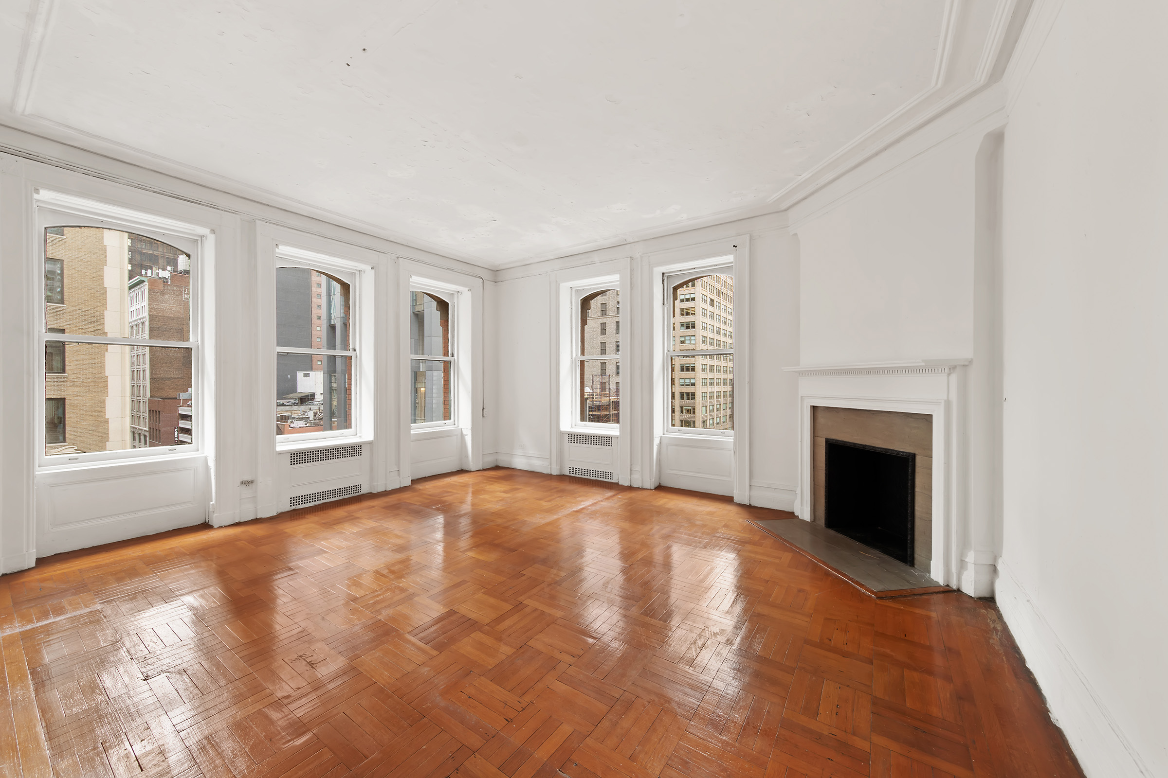 284 5th Avenue, Unit 6E Manhattan, NY 10001 - Photo 4 of 12 a view of an empty room with window and fire place