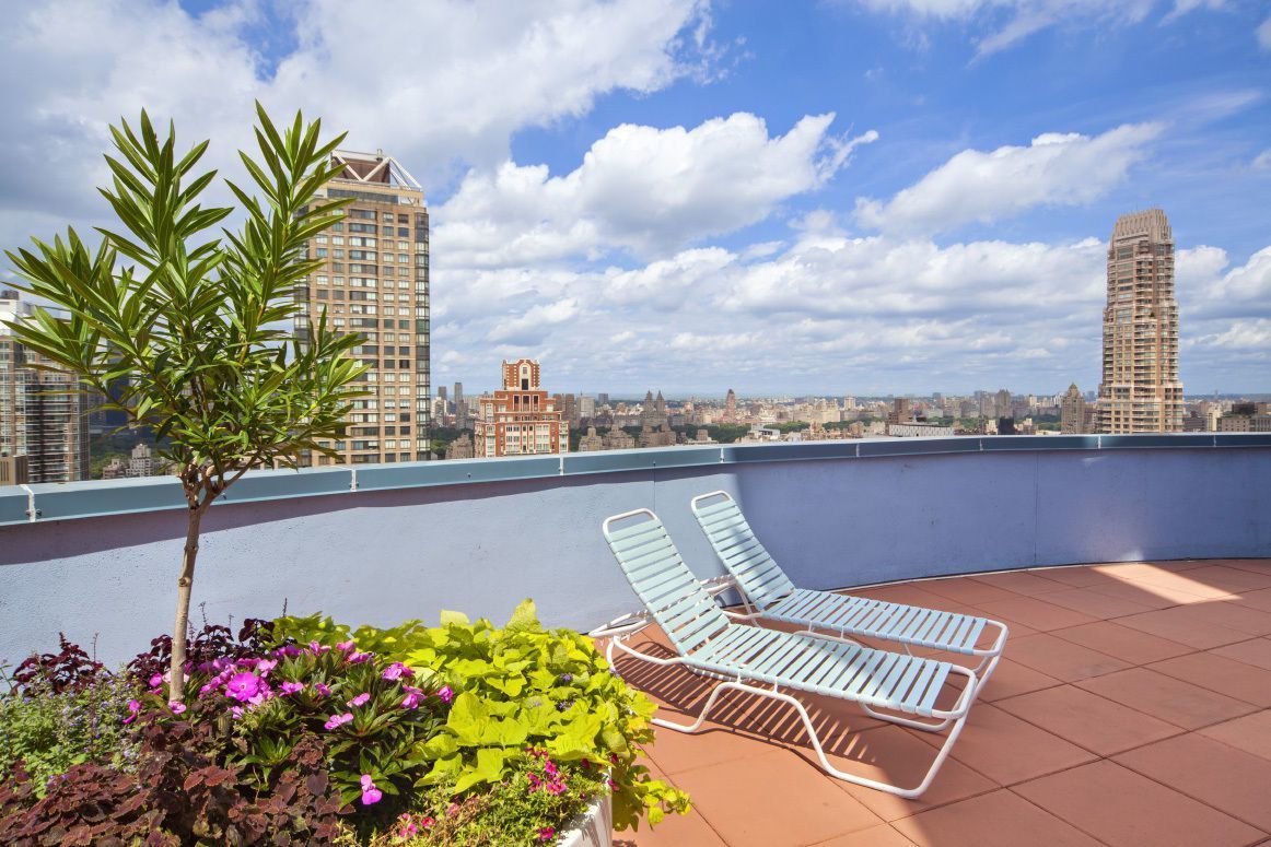 304 East 65th Street, Unit 6D Manhattan, NY 10065 - Photo 10 of 15 a view of a balcony with wooden floor and a bench