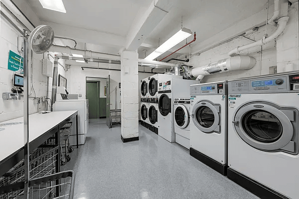 13 West 13th Street, Unit 2DS Manhattan, NY 10011 - Photo 9 of 19 a utility room with sink dryer and washer
