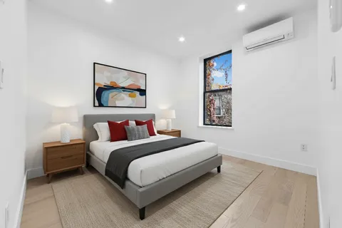 a bed room with a bed and a wall painting