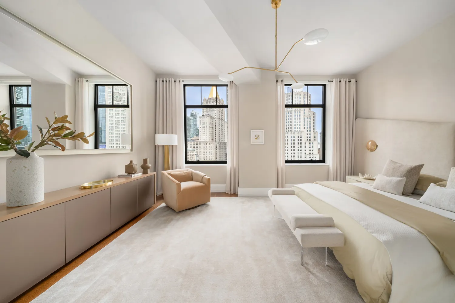 a spacious bedroom with a bed couch and windows