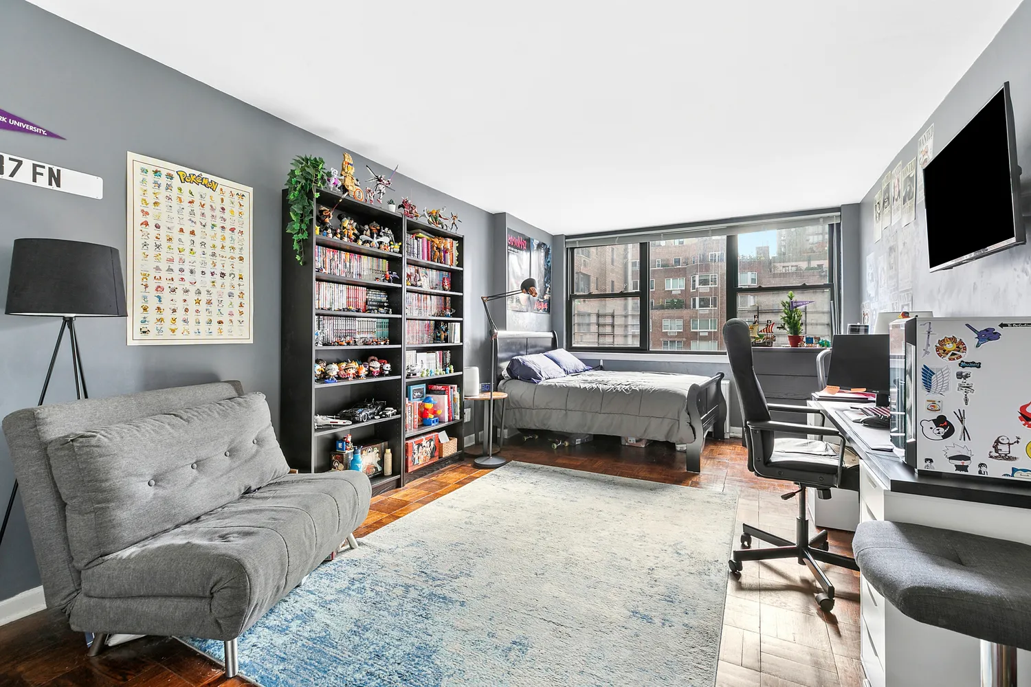 a bedroom with furniture and a flat screen tv