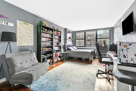 a bedroom with furniture and a flat screen tv