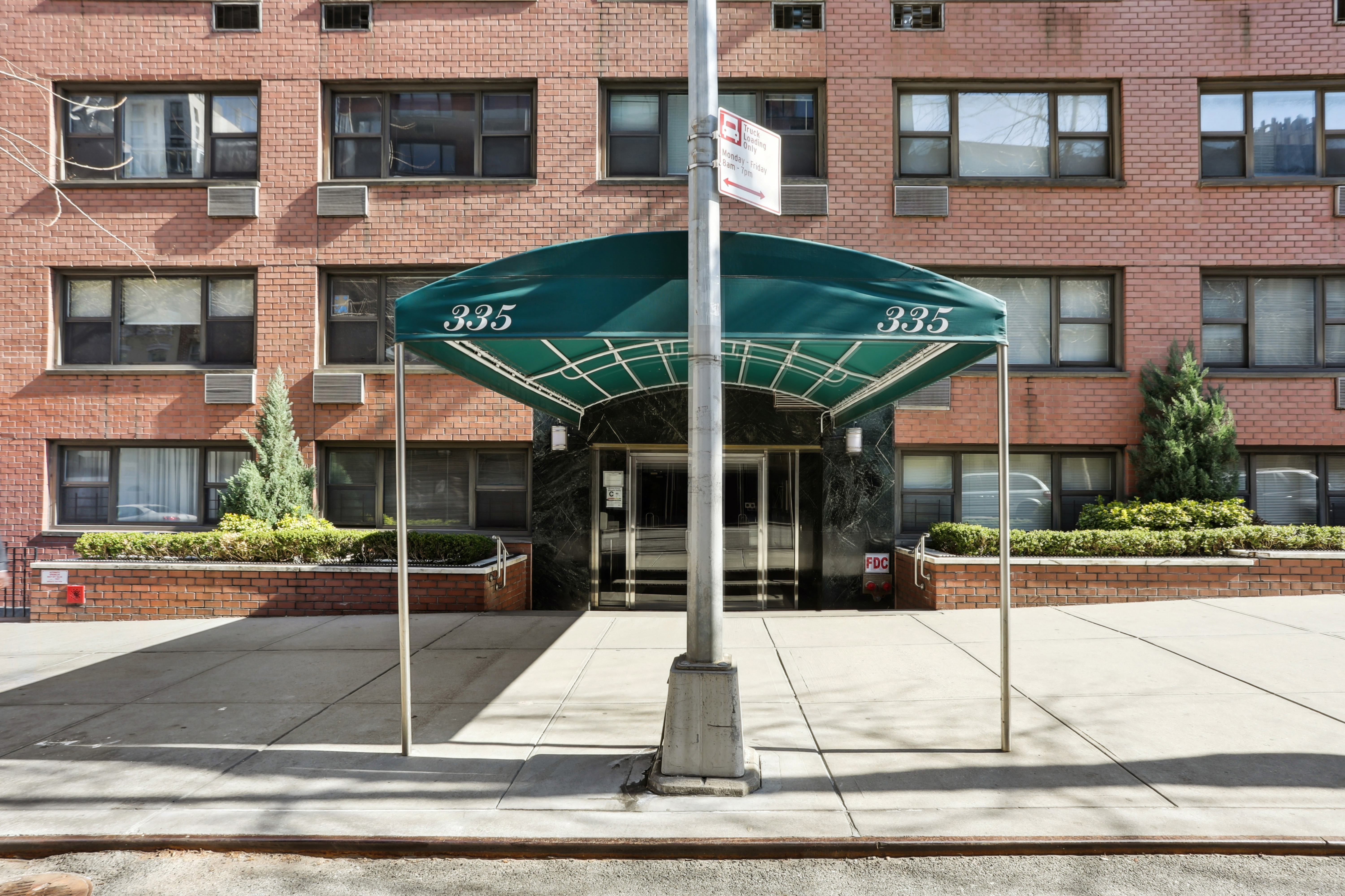 335 East 51st Street, Unit 4H Manhattan, NY 10022 - Photo 12 of 13 front view of house with a street