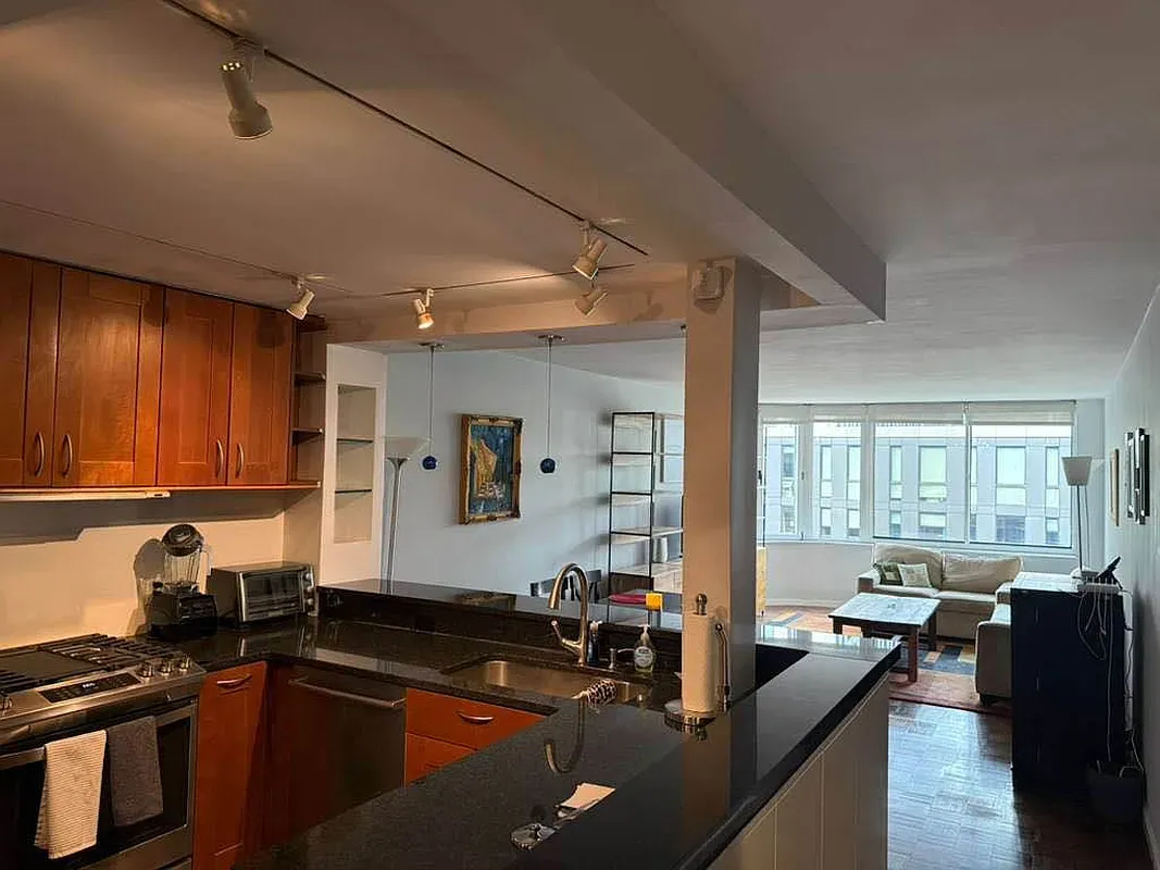 a kitchen with sink refrigerator and window