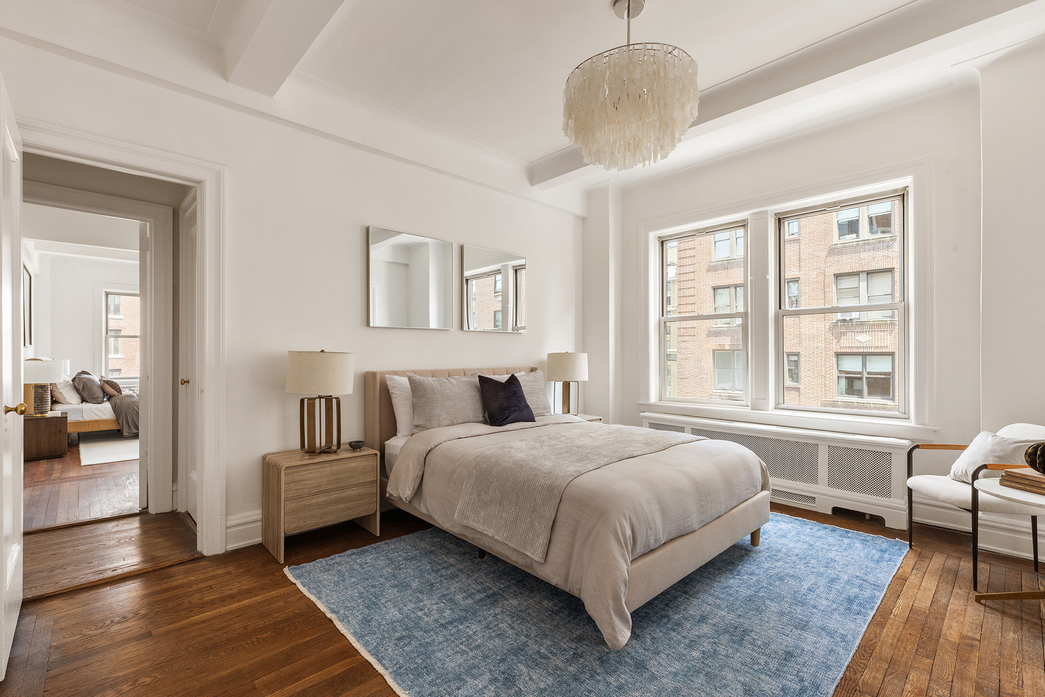 975 Park Avenue, Unit 10B Manhattan, NY 10028 - Photo 11 of 17 a spacious bedroom with a bed a couch and a window