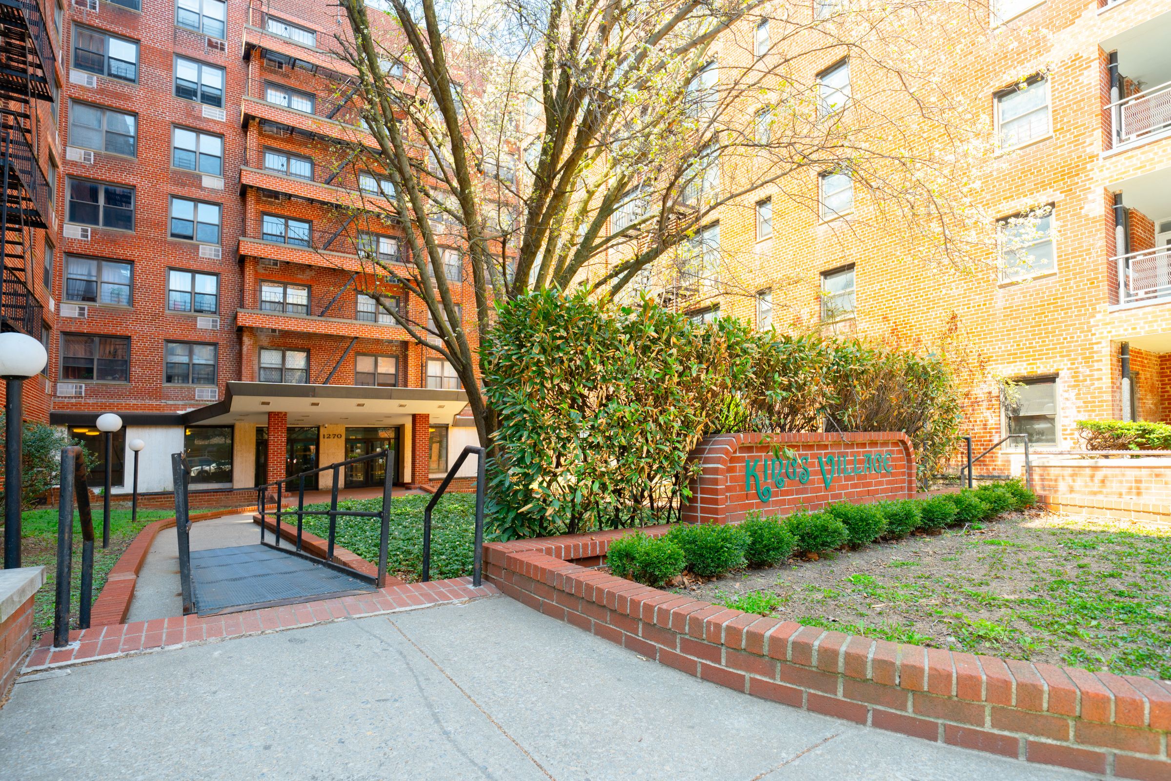 1270 East 51st Street, Unit 6M Brooklyn, NY 11234 - Photo 11 of 12 a front view of a building with a garden and plants