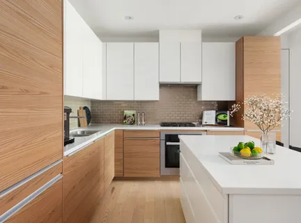 a kitchen with a sink a stove cabinets and wooden floor