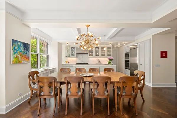 a view of a dining room with furniture and chandelier