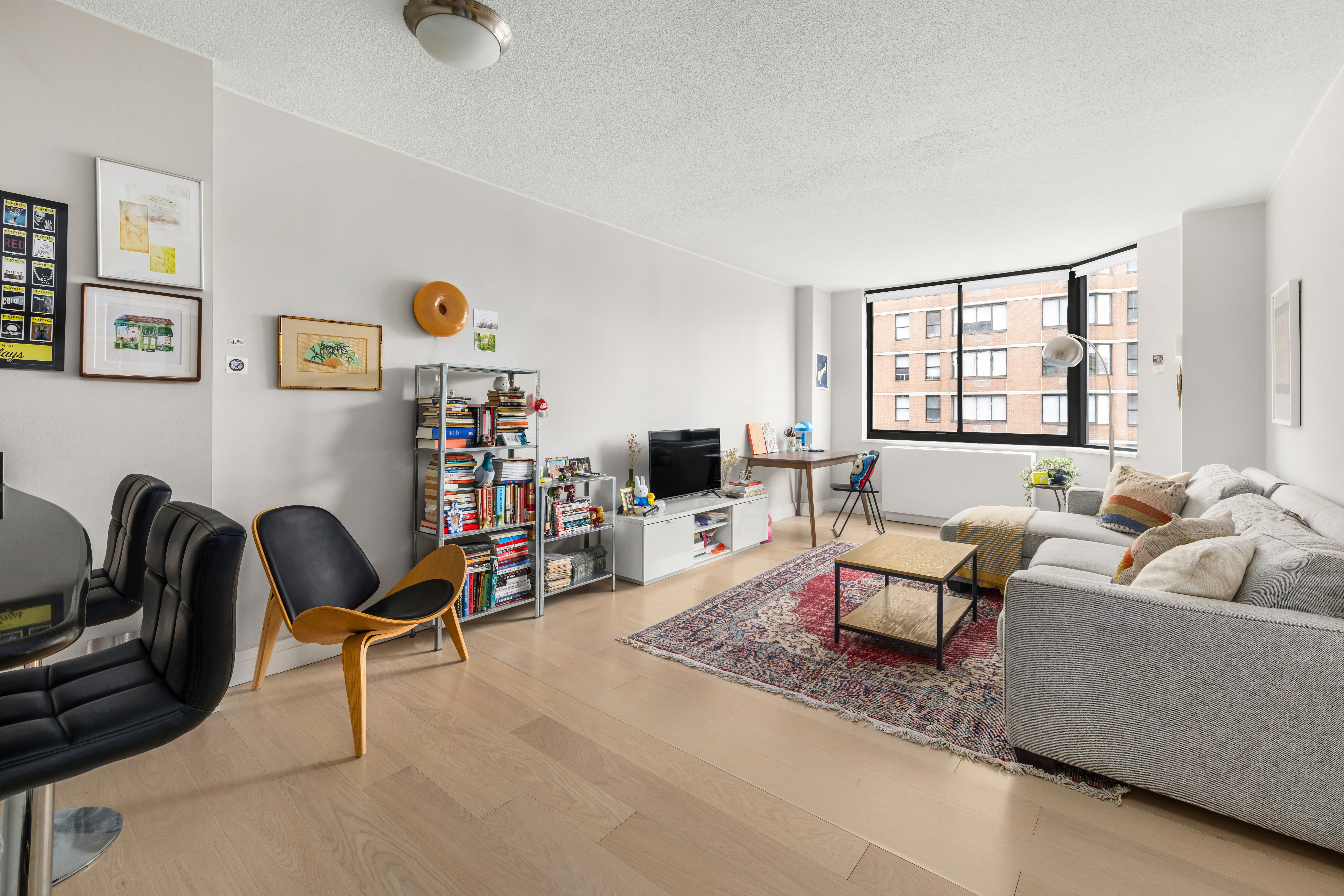 151-155 East 31st Street, Unit 12C Manhattan, NY 10016 - Photo 2 of 7 a living room with furniture and a flat screen tv