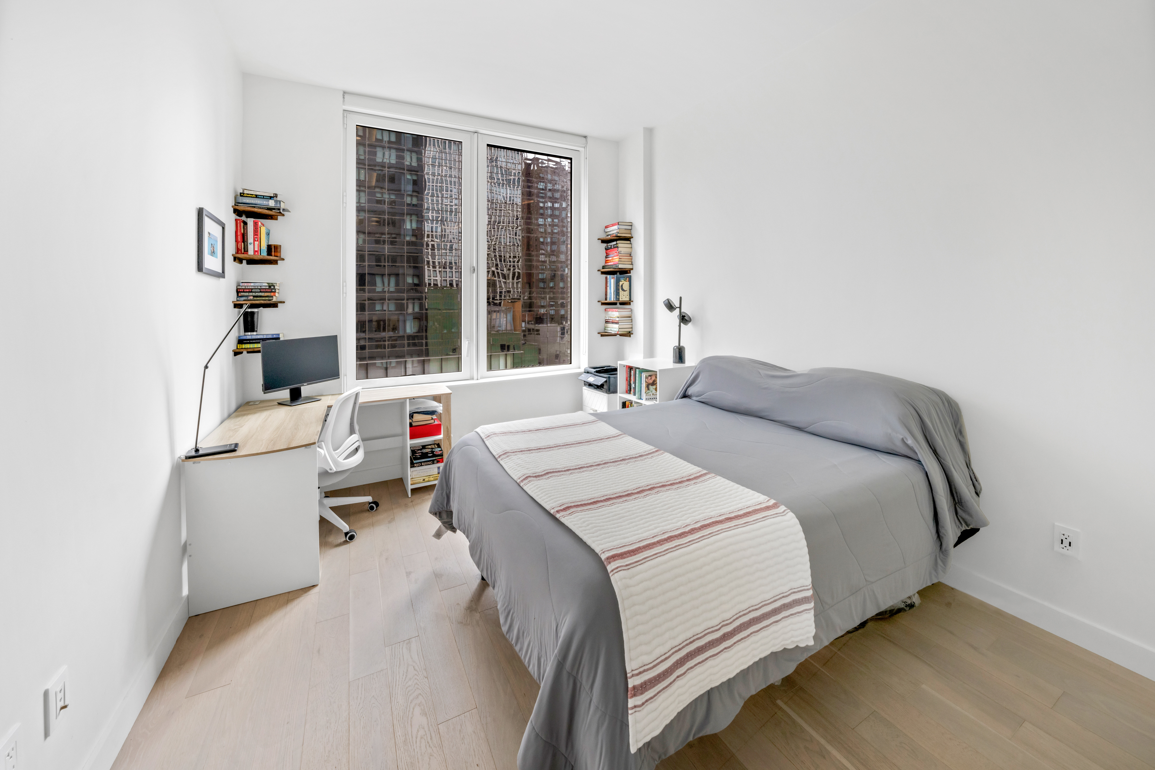 1 West 60th Street, Unit 16C Manhattan, NY 10019 - Photo 5 of 8 a bedroom with a bed and a large window