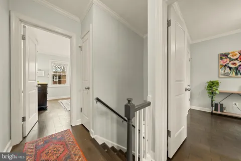 a view of a hallway view with wooden floor and furniture