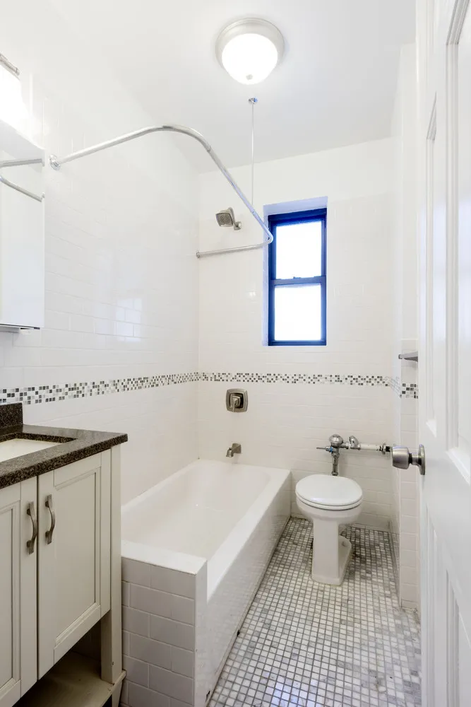 a bathroom with a sink a toilet and a mirror