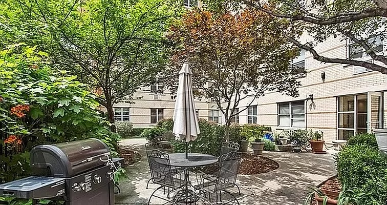 1831 Madison Avenue, Unit 9E Manhattan, NY 10035 - Photo 16 of 18 a view of a chair and tables in the backyard of the house