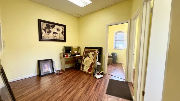 a view of a workspace with furniture and gym equipment