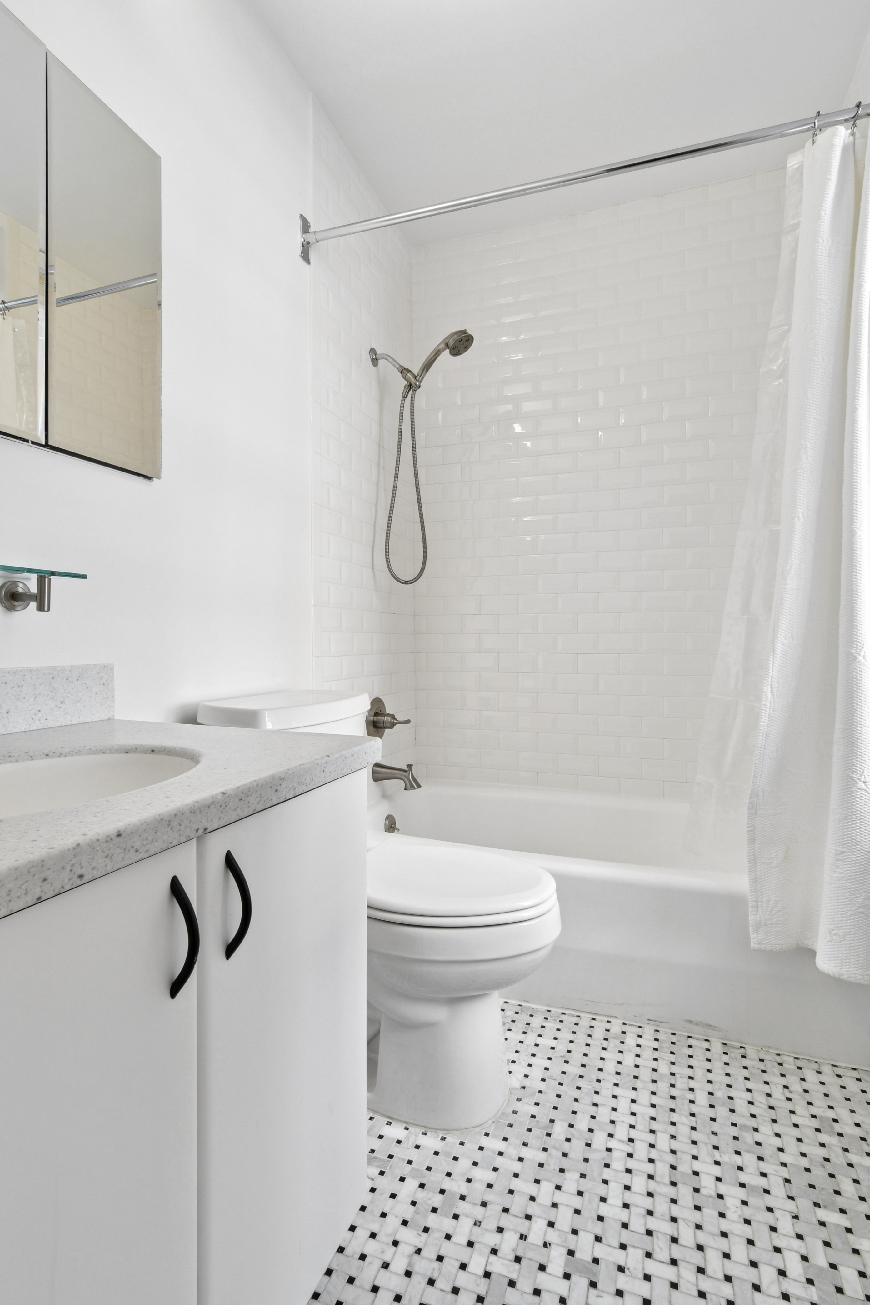 109 East 38th Street, Unit 3A Manhattan, NY 10016 - Photo 11 of 13 a bathroom with a granite countertop sink toilet and shower
