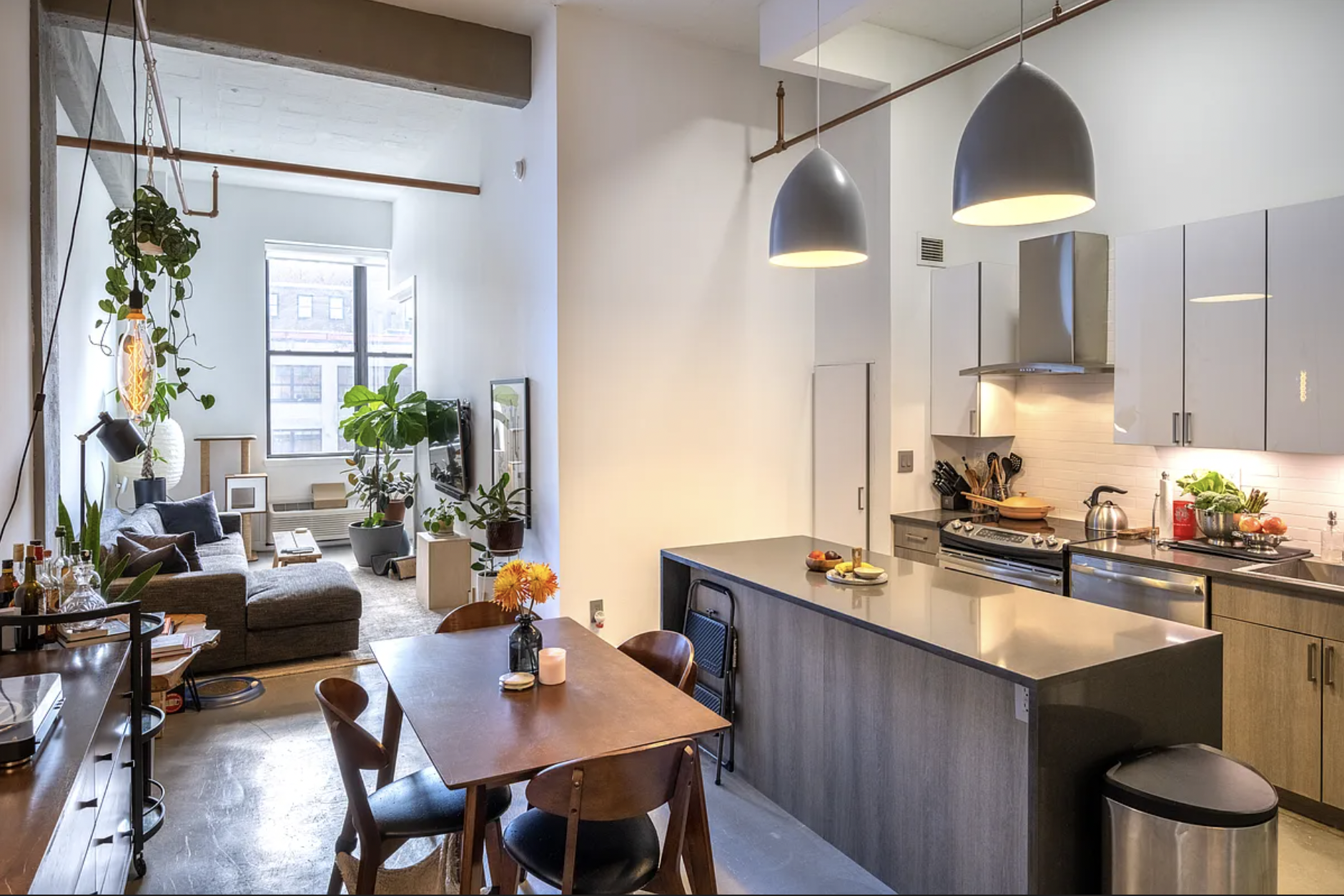 44 Berry Street, Unit 5E Brooklyn, NY 11249 - Photo 2 of 9 a kitchen with a stove a refrigerator and a dining table with wooden floor