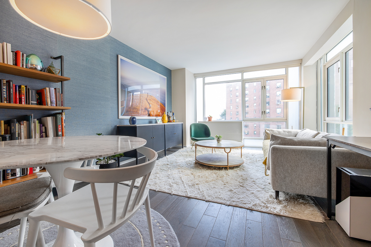 385 1st Avenue, Unit 6G Manhattan, NY 10010 - Photo 2 of 19 a living room with furniture and a large window