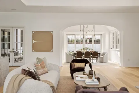 a living room with furniture and a chandelier