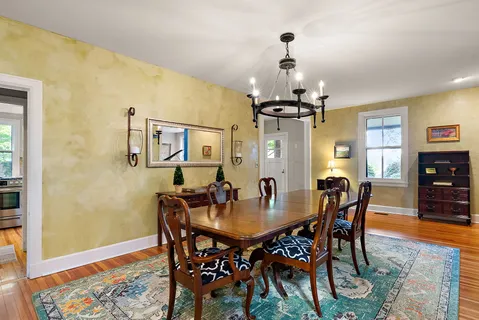 a view of a dining room with furniture and wooden floor