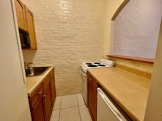 1105 1st Avenue, Unit 9 Manhattan, NY 10065 - Photo 4 of 8 a utility room with a sink a washer and dryer