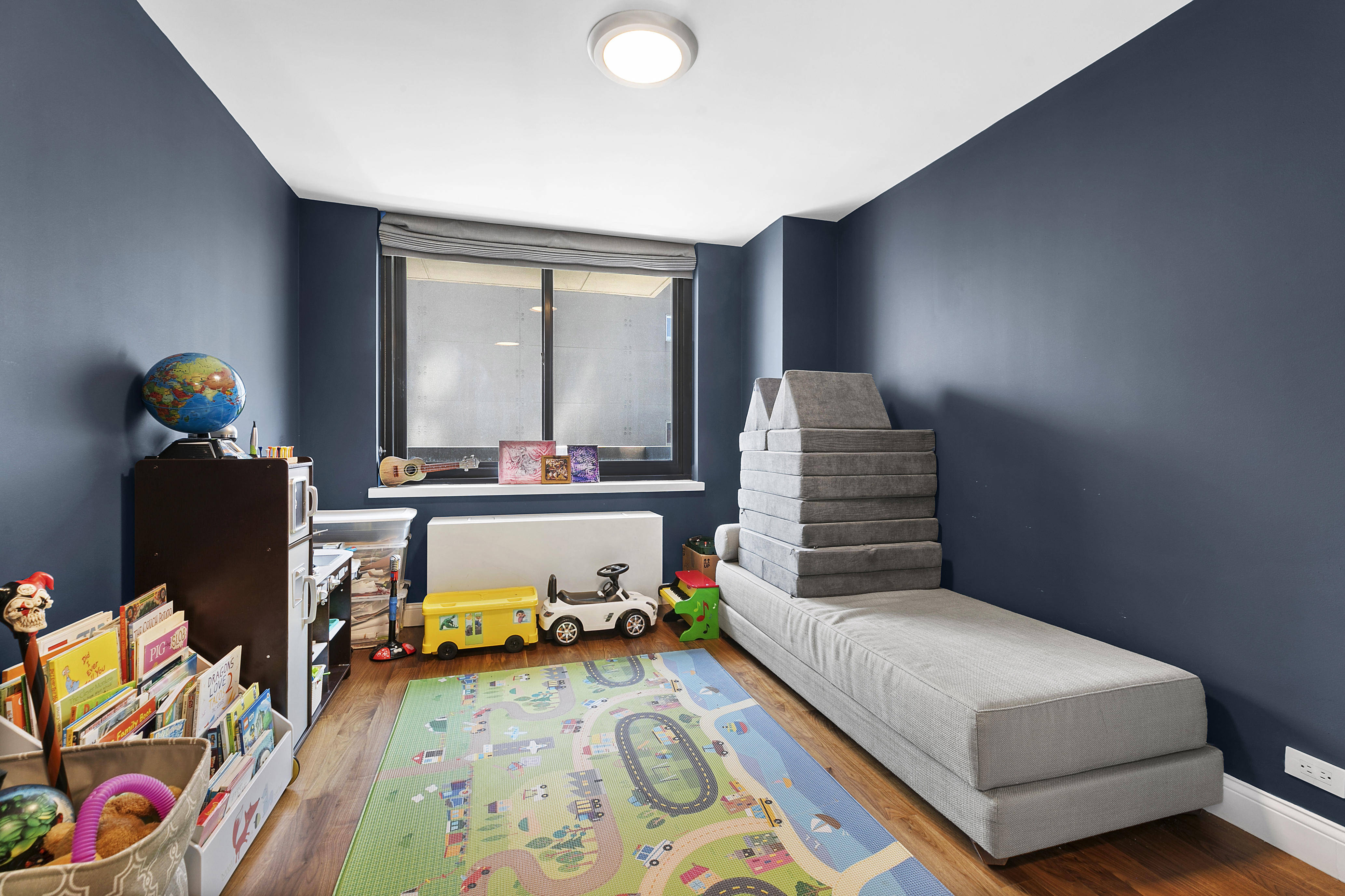 515 East 72nd Street, Unit 9J Manhattan, NY 10021 - Photo 5 of 17 a bedroom with a bed and wooden floor