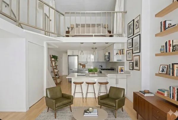 a kitchen with stainless steel appliances kitchen island granite countertop a refrigerator and cabinets