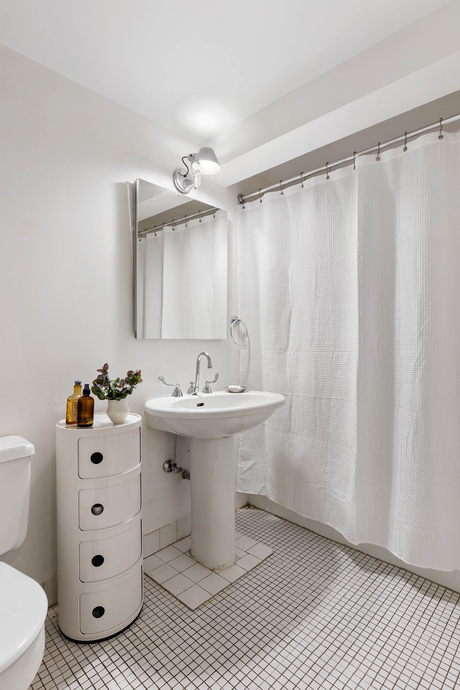 166 Bank Street, Unit 6B Manhattan, NY 10014 - Photo 8 of 16 a bathroom with a sink toilet and shower