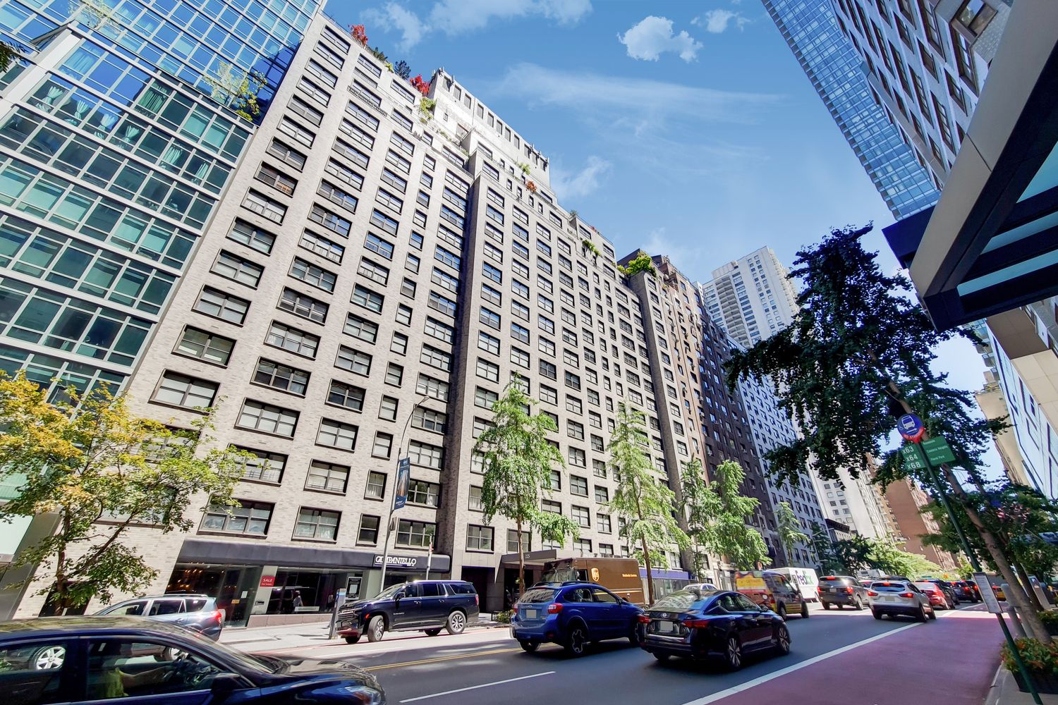 225 East 57th Street, Unit 5K Manhattan, NY 10022 - Photo 10 of 11 a couple of cars parked in front of a building