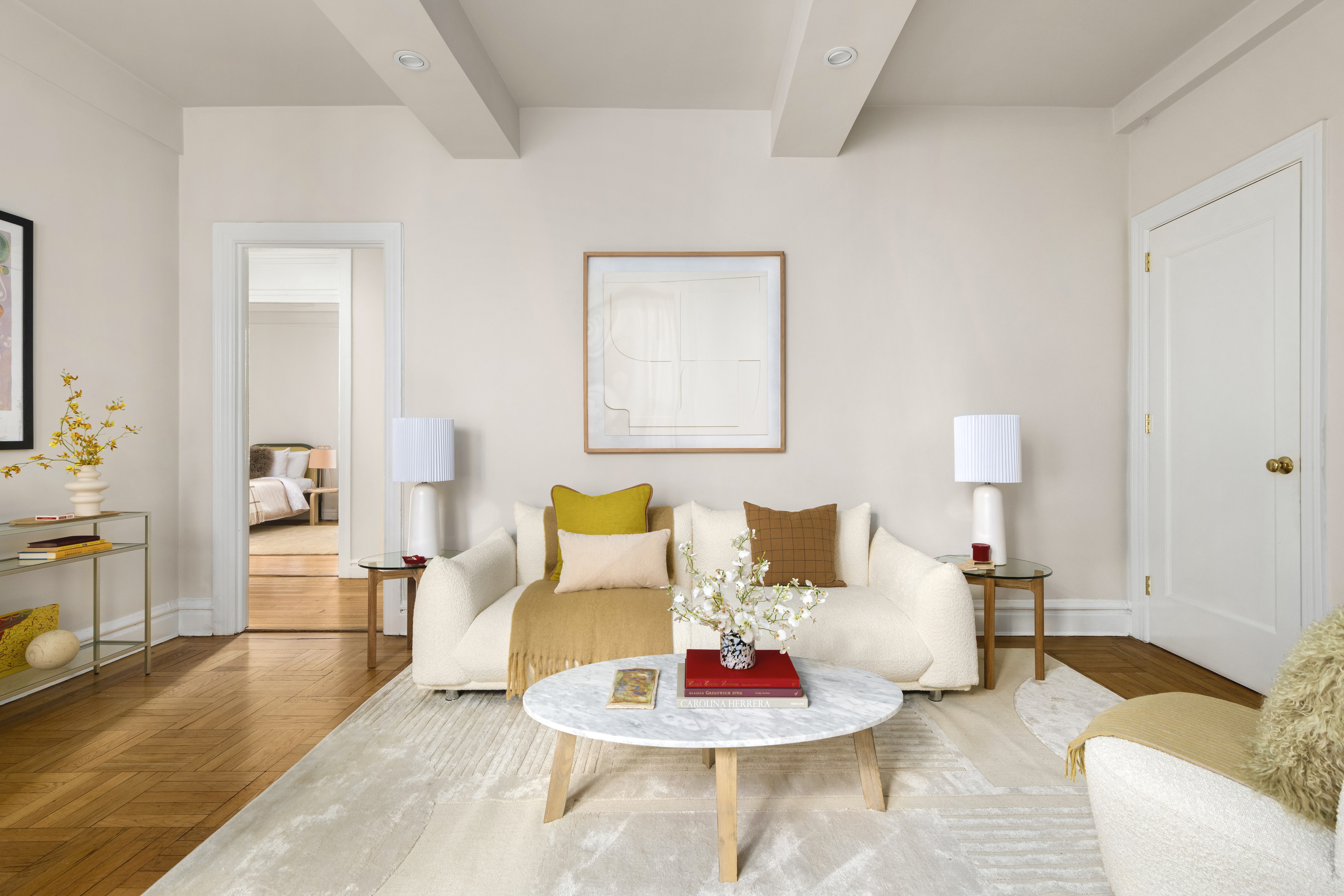 a living room with furniture and wooden floor