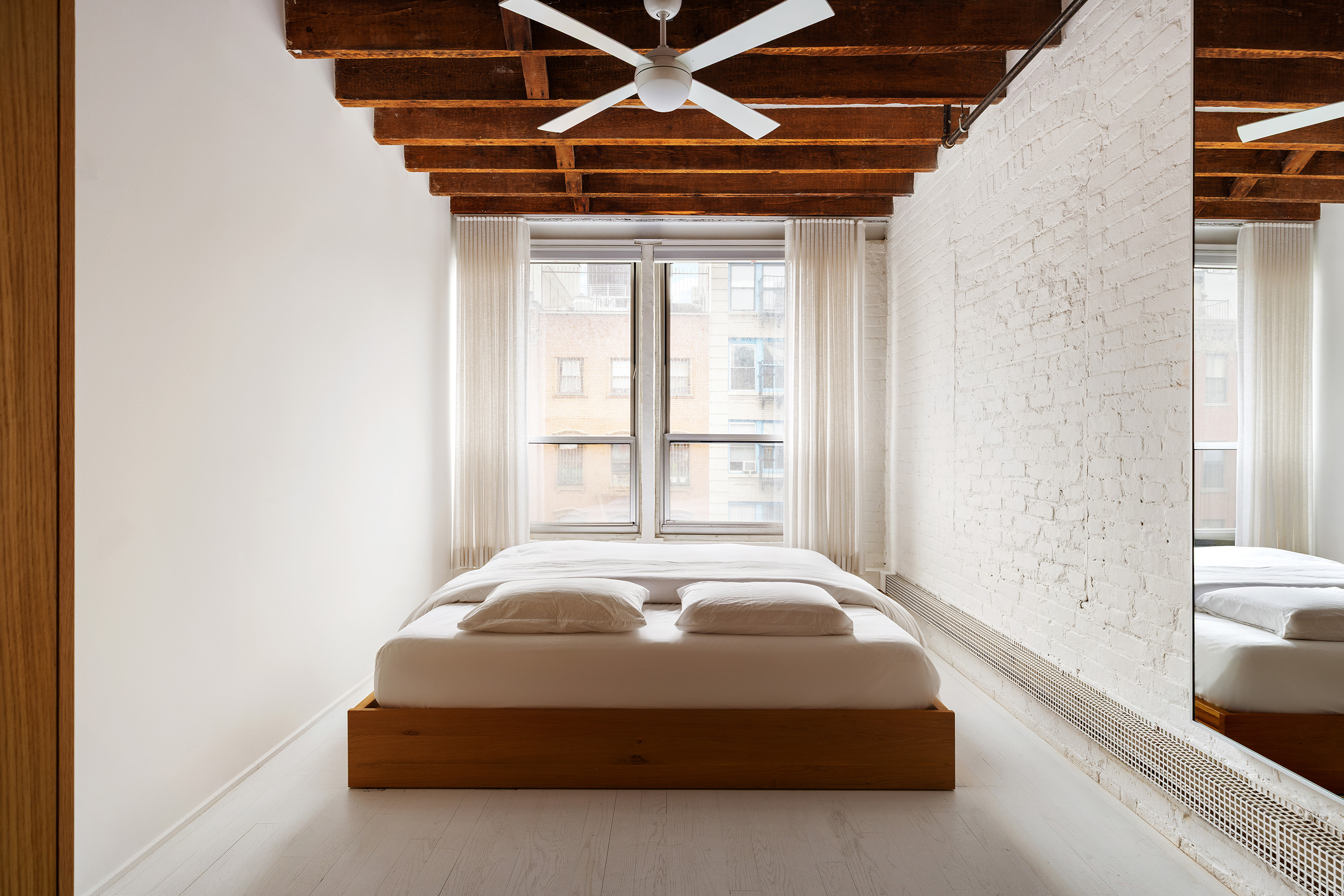 48 Canal Street, Unit 4 Manhattan, NY 10002 - Photo 6 of 13 a spacious bedroom with a bed and a window