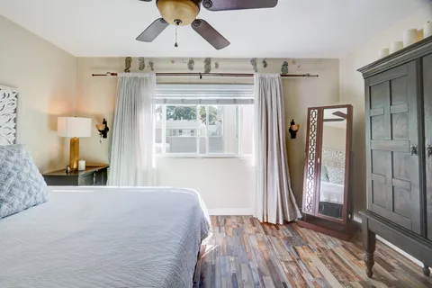 a bedroom with a bed and a mirror