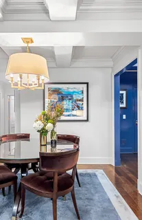 a dining room with furniture and wooden floor