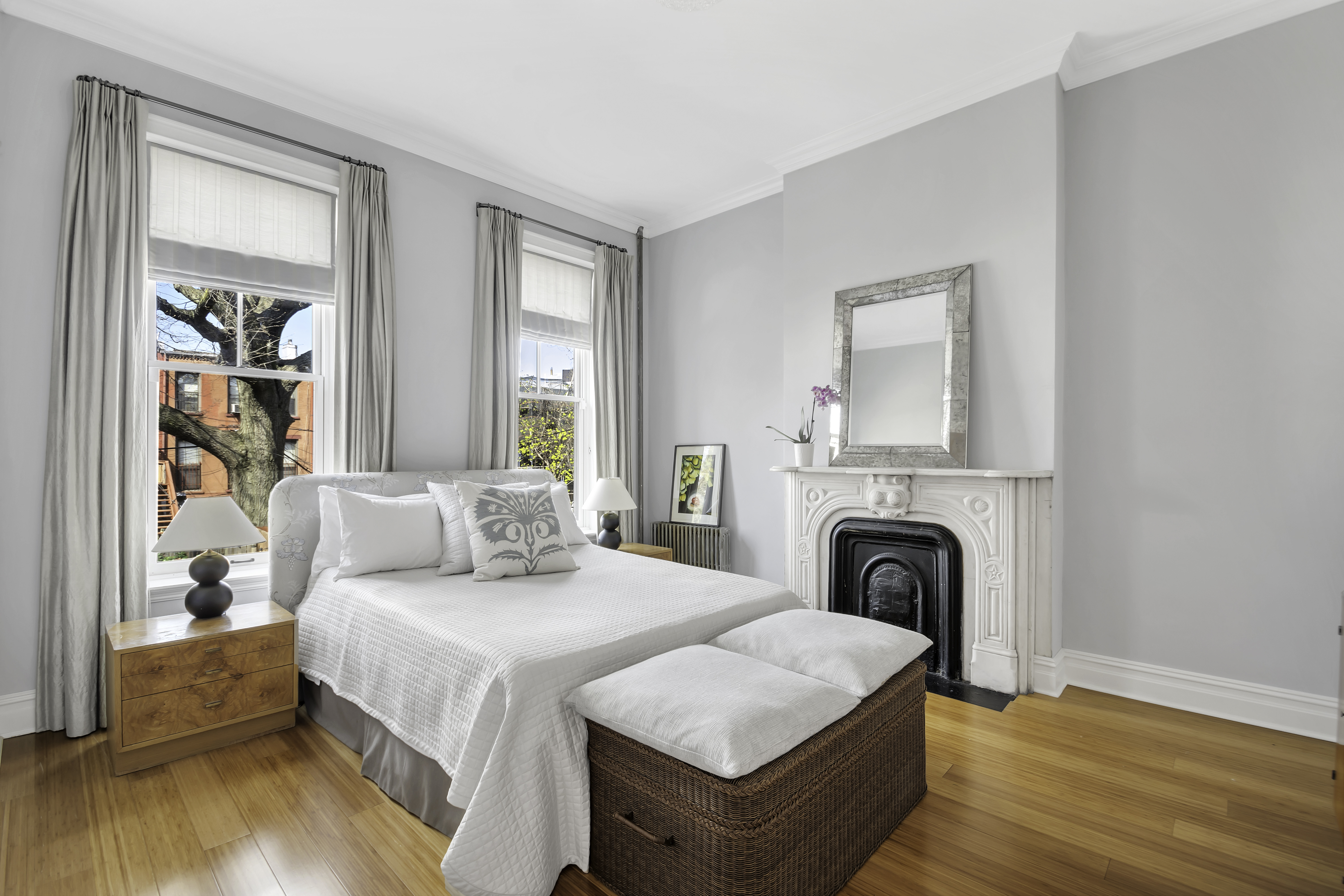 713 Greene Avenue, Unit GARDEN Brooklyn, NY 11221 - Photo 5 of 13 a bedroom with a bed and a fireplace
