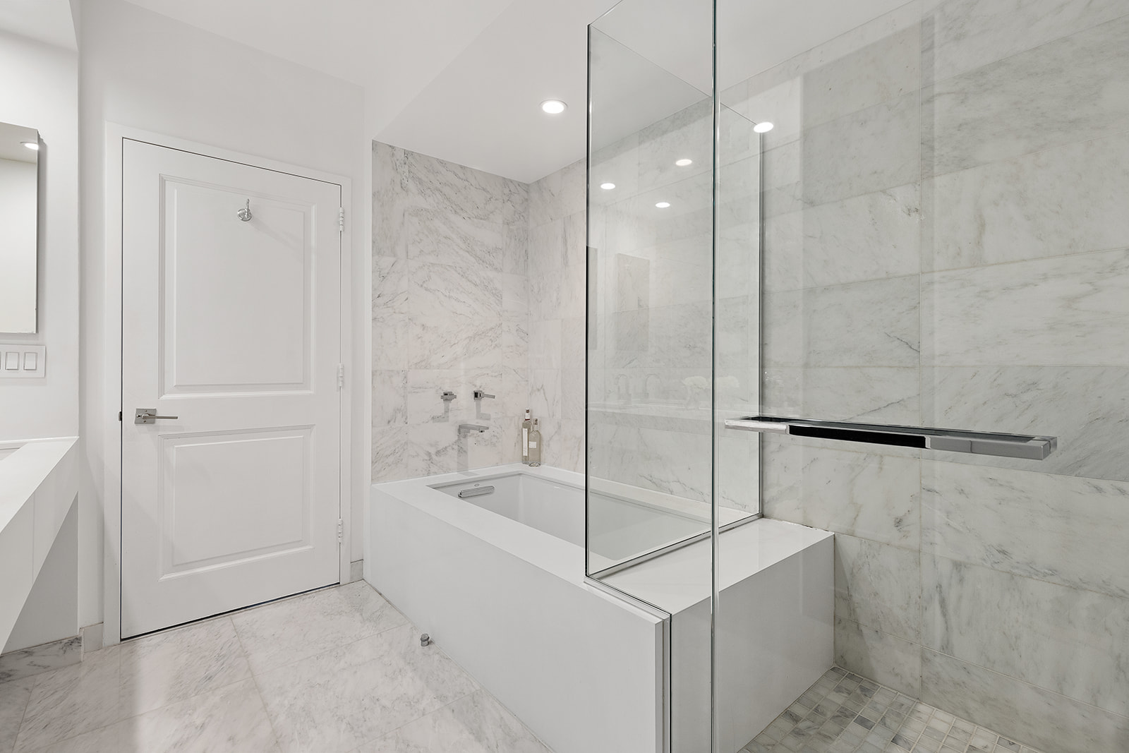 300 East 77th Street, Unit 18C Manhattan, NY 10075 - Photo 7 of 12 a bathroom with a bathtub and a shower