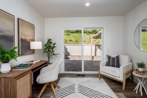 a living room with furniture and a potted plant