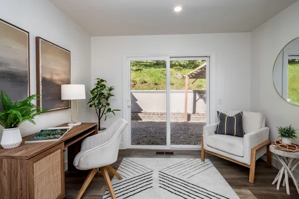 a living room with furniture and a potted plant