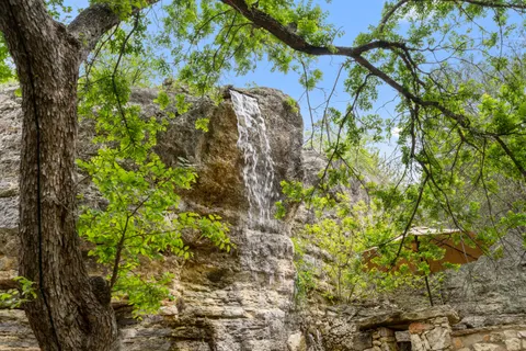 a bathroom with a granite countertop sink a toilet and shower