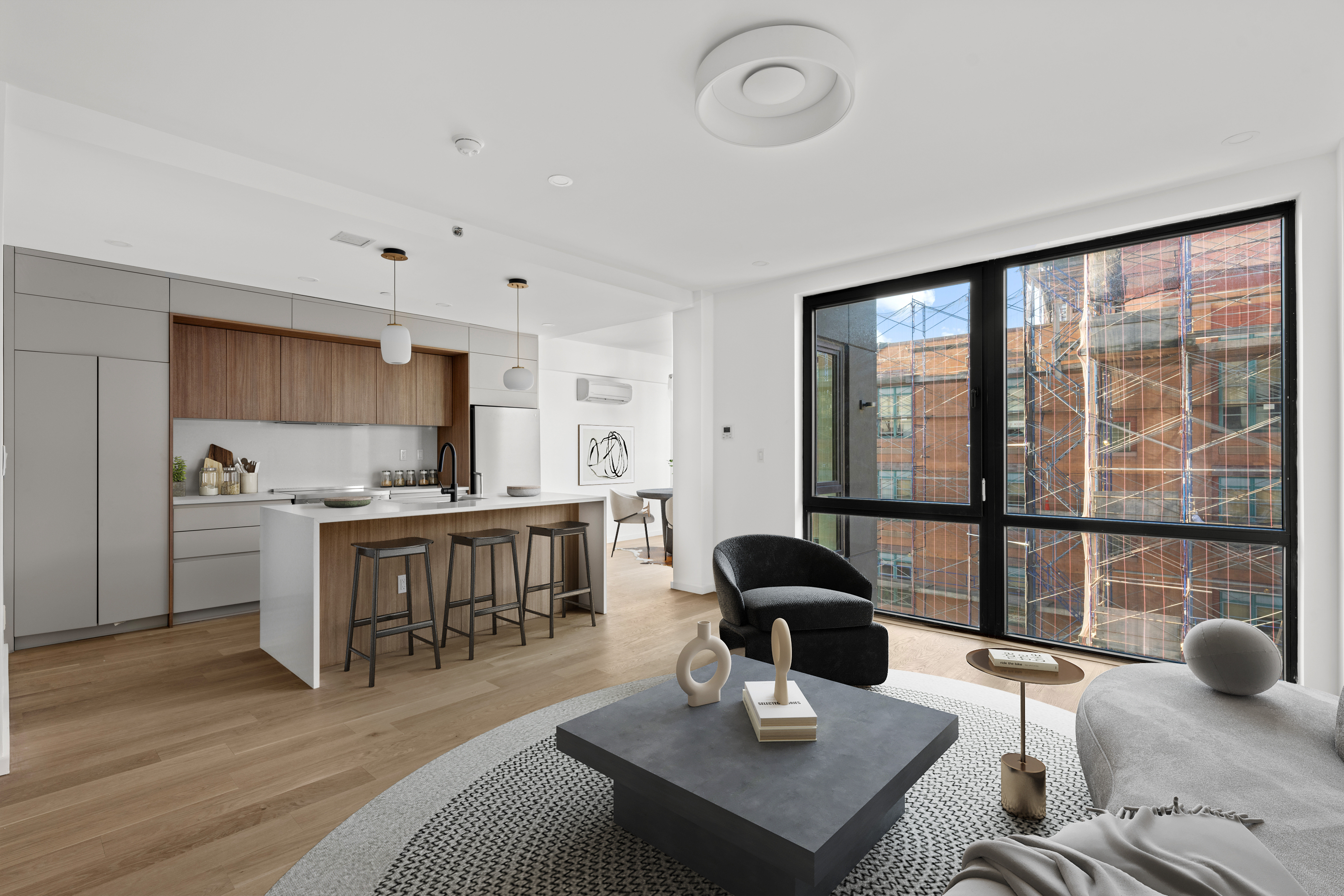 14-35 Broadway, Unit PH Queens, NY 11106 - Photo 10 of 24 a work room with furniture and view of kitchen